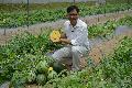 Agricultural Officer of the AFCD, Dr Chen Yi-min, holds a yellow orchid, a new watermelon species from Thailand.