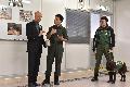 The Secretary for the Environment, Mr Wong Kam-sing (first left), is briefed by the Quarantine Detector Dog Team Trainer of the Agriculture, Fisheries and Conservation Department on the training of quarantine detector dogs (QDD) for detecting ivory today (January 28). 