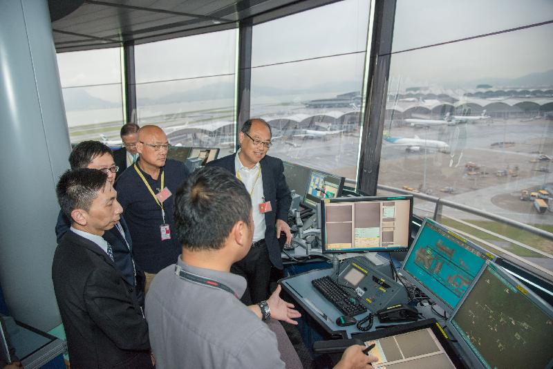 Legislative Council Members, Dr Lam Tai-fai (first right) and Mr Albert Chan (second right), visit the North Tower of the Air Traffic Control Complex of the Civil Aviation Department today (July 12) to learn more about the aerodrome traffic control operation.