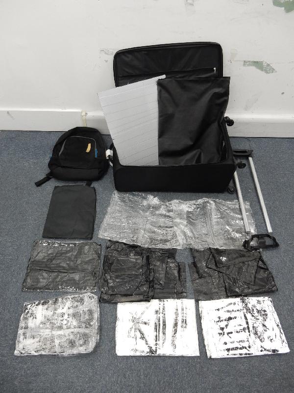Hong Kong Customs seized about 2.1 kilograms of suspected cocaine, with a market value of about $2.2 million, at Hong Kong International Airport yesterday (July 14). The suspected cocaine was found concealed inside the false compartments of a suitcase and a backpack placed inside the suitcase.