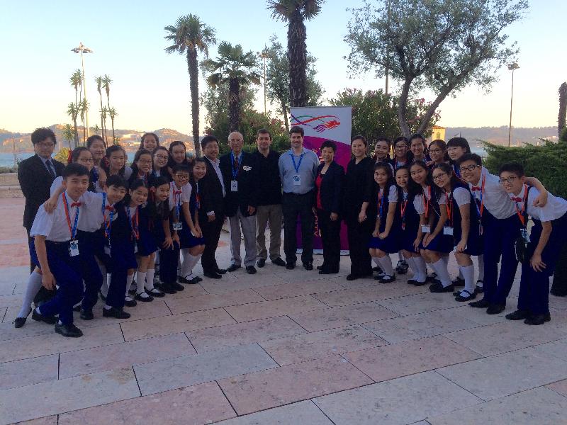 The Hong Kong Children's Choir at the reception hosted by HKETO, Brussels in Lisbon on July 26 (Lisbon time) is pictured with (from left): the General Manager of the Hong Kong Children's Choir (HKCC), Mr Wilson Tse;  the conductor / accompanist of the HKCC, Mr Dominic Lam; the Director of the HKCC, Mr Fung Yuen; the Artistic Director of Lisbon International Youth Music Festival, Mr Rui Fernandes; the Festival Director, Mr Tiago Neto; the Deputy Representative of the Hong Kong Economic and Trade Office in Brussels, Miss Drew Lai and the Music Director and Principal Conductor of the HKCC, Ms Kathy Fok.