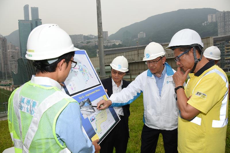 The Secretary for Development, Mr Paul Chan, inspected the underground stormwater storage tank and related facilities at the Happy Valley Underground Stormwater Storage Scheme of the Drainage Services Department (DSD) today (August 1). Picture shows Mr Chan (first right) being briefed by the Director of Drainage Services, Mr Edwin Tong (second right) on the DSD's flood prevention measures in response to the threat of Typhoon Nida to Hong Kong.