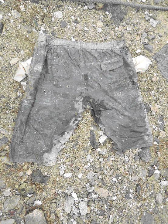 The upper body of the deceased was naked while the lower body was wearing dark colour shorts.