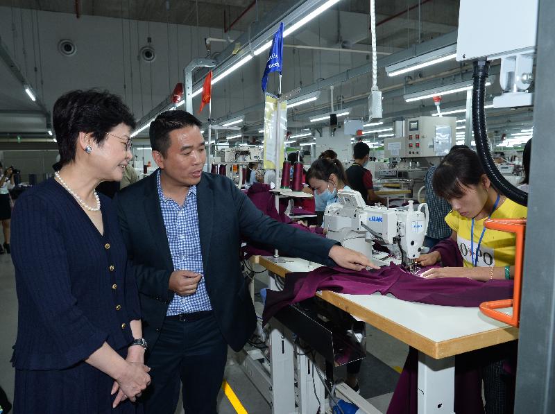 The Chief Secretary for Administration, Mrs Carrie Lam (left), visits an apparel factory owned by a Hong Kong-based global company in Hanoi, Vietnam, today (August 18).