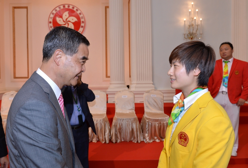 The Chief Executive, Mr C Y Leung, hosted a reception for the visiting delegation of Rio Olympic Games Mainland Olympians today (August 27) at Government House. Picture shows Mr Leung (left) chatting with member of the delegation, table tennis athlete Ding Ning (right) at the reception.