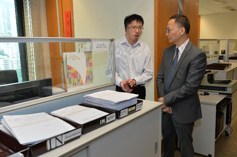 The Secretary for the Civil Service, Mr Clement Cheung (right), today (September 22) speaks with one of several persons with disabilities employed at the Land Registry to learn more about his daily duties and work experience.