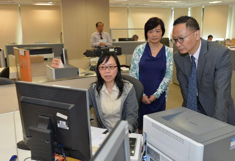 During a visit to the Land Registry today (September 22), the Secretary for the Civil Service, Mr Clement Cheung (right), learns more about the deeds lodgement services.
