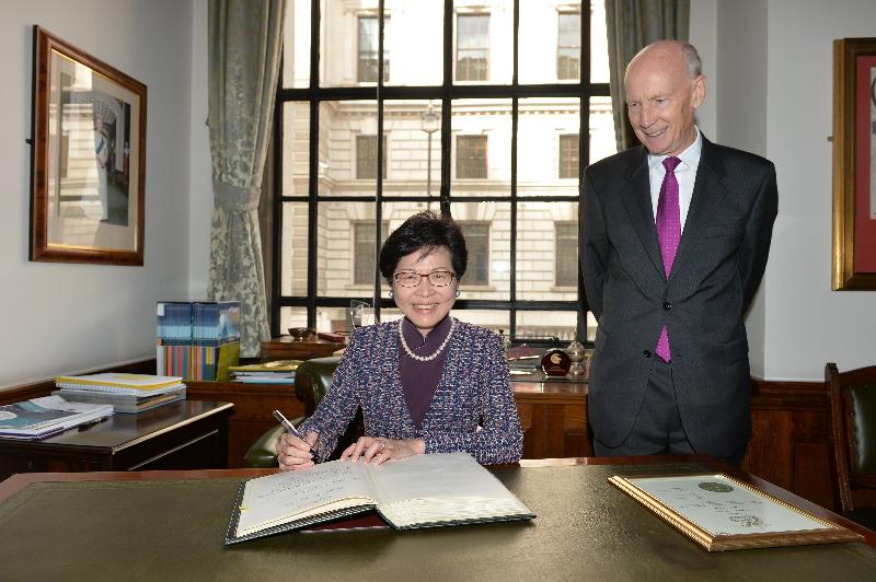 The Chief Secretary for Administration, Mrs Carrie Lam (left) signs a roll as an Honorary Fellow of Institution of Civil Engineers (ICE), witnessed by the Vice President of ICE, Professor Lord Robert Mair, today (September 26, London time).