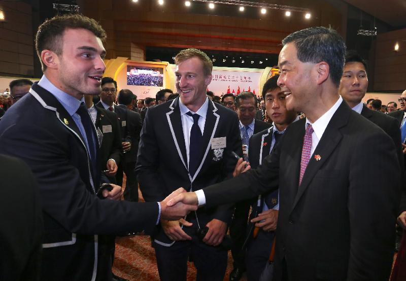 The Chief Executive, Mr C Y Leung (right), chats with guests at a reception in celebration of the 67th anniversary of the founding of the People's Republic of China at the Grand Hall of the Hong Kong Convention and Exhibition Centre this morning (October 1).