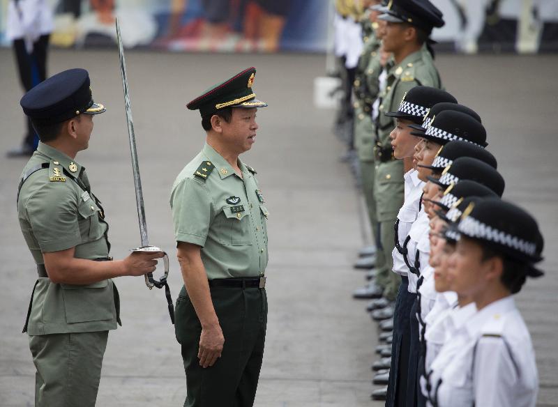 The Deputy Commander of the Chinese People's Liberation Army Hong Kong Garrison, Major General Liao Zhengrong (centre), inspects a contingent of correctional officers during the Correctional Services Department (CSD) passing-out parade at the Staff Training Institute of the CSD in Stanley today (October 7).