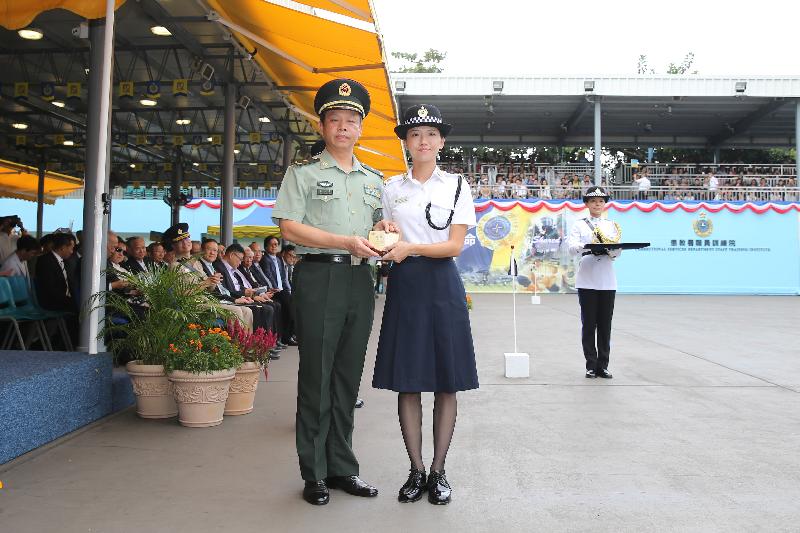 The Deputy Commander of the Chinese People's Liberation Army Hong Kong Garrison, Major General Liao Zhengrong (left), presents a Best Recruit Award, the Principal's Shield, to Officer Ms Tse Kit-ying while attending the Correctional Services Department (CSD) passing-out parade at the Staff Training Institute of the CSD in Stanley today (October 7).
