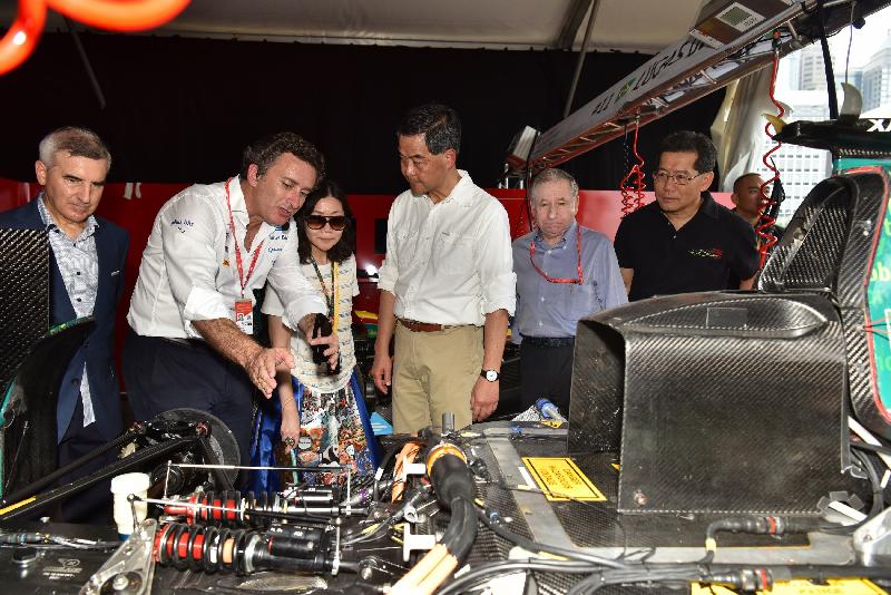 The Chief Executive, Mr C Y Leung (fourth left), tours the pit lane for the 2016 FIA Formula E Hong Kong ePrix in Central today (October 9). Looking on are the Secretary for Commerce and Economic Development, Mr Gregory So (sixth left) and the Commissioner for Tourism, Miss Cathy Chu (third left).