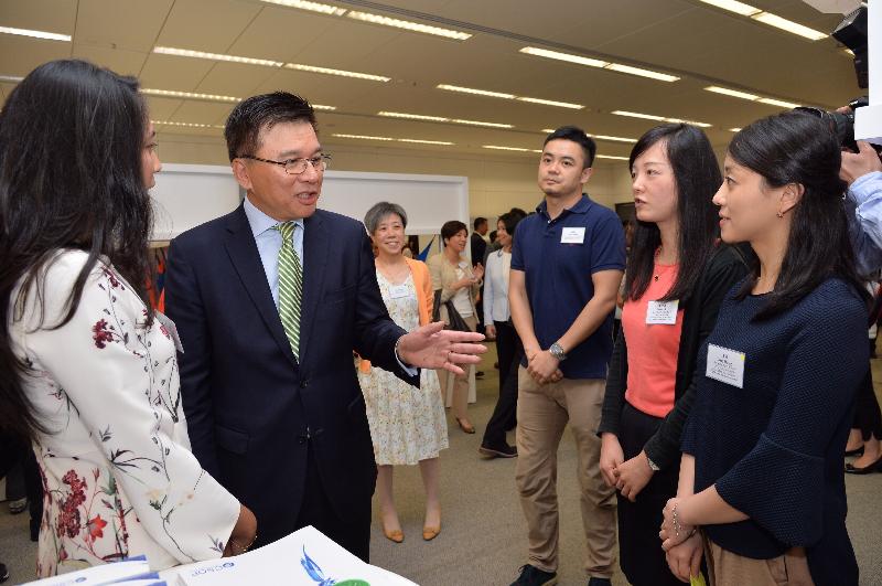 The Secretary for Financial Services and the Treasury, Professor K C Chan (second left), learns about staff recruitment and career opportunities in the asset and wealth management sector from a booth exhibitor at the Launching Ceremony-cum-Industry Promotion under the Pilot Programme to Enhance Talent Training for the Asset and Wealth Management Sector today (October 15).