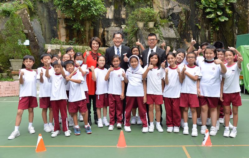The Secretary for Commerce and Economic Development, Mr Gregory So (back row, centre), is pictured with students of Li Sing Tai Hang School during his district visit to Wan Chai today (October 20).