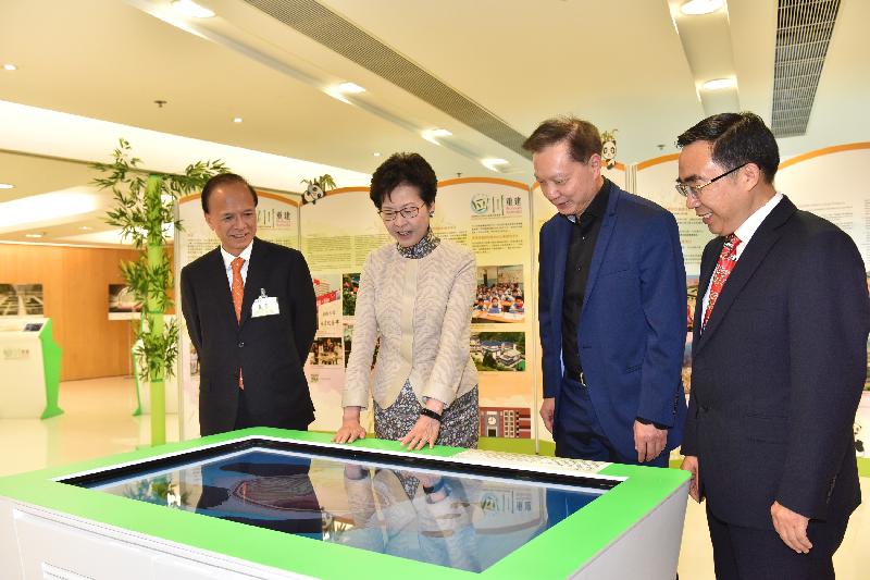 The Chief Secretary for Administration, Mrs Carrie Lam, officiated at the Hong Kong Special Administrative Region (HKSAR)'s Post-quake Reconstruction Support Work in Sichuan Completion Ceremony cum Sharing Session on Reconstruction of the Wolong National Nature Reserve today (October 28). Photo shows Mrs Lam (second left); the Director of the Sichuan Wolong National Nature Reserve Administration, Mr Zhang Hemin (first right); and the Chief Executive of Ocean Park Corporation, Mr Matthias Li (first left), accompanied by the Deputy Team Leader (Sichuan Reconstruction) of the Development Bureau, Mr David Tong (second right), touring the exhibition of the HKSAR's post-quake reconstruction support work in Sichuan.