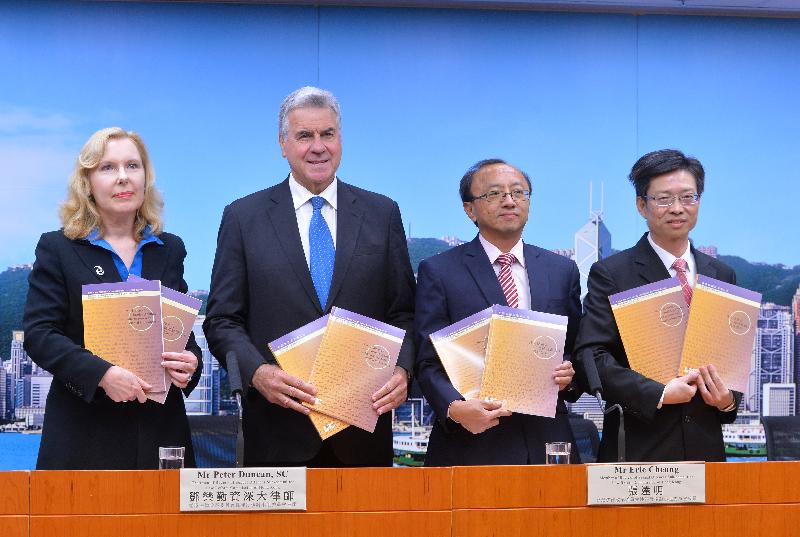 The Chairman of the Review of Sexual Offences Sub-committee of the Law Reform Commission (LRC), Mr Peter Duncan, SC (second left); Sub-committee member, Mr Eric Cheung (second right); the Secretary of the LRC, Ms Michelle Ainsworth (first left), and the Secretary of the Sub-committee, Mr Thomas Leung (first right), hold copies of the consultation paper on sexual offences involving children and persons with mental impairment at today's (November 1) press conference.