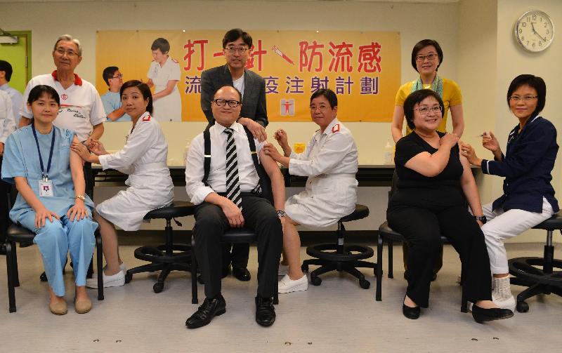 The Secretary for Food and Health, Dr Ko Wing-man (back row, centre), the Director of Health, Dr Constance Chan (back row, right) and the Chairman of the Hospital Authority, Professor John Leong (back row, left) today (November 4) observe the Deputy Secretary for Food and Health (Health), Mr Howard Chan (front row, centre), the Regional Nursing Officer of the Department of Health, Ms Mary Foong (front row, right) and a public doctor (front row, left) receiving their seasonal influenza vaccinations.