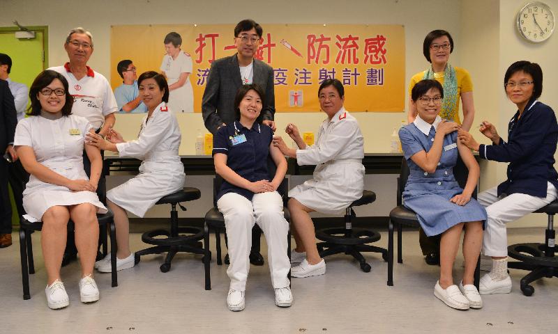 The Secretary for Food and Health, Dr Ko Wing-man (back row, centre), the Director of Health, Dr Constance Chan (back row, right) and the Chairman of the Hospital Authority, Professor John Leong (back row, left) today (November 4) observe frontline healthcare professionals of the public sector receiving seasonal influenza vaccinations.
