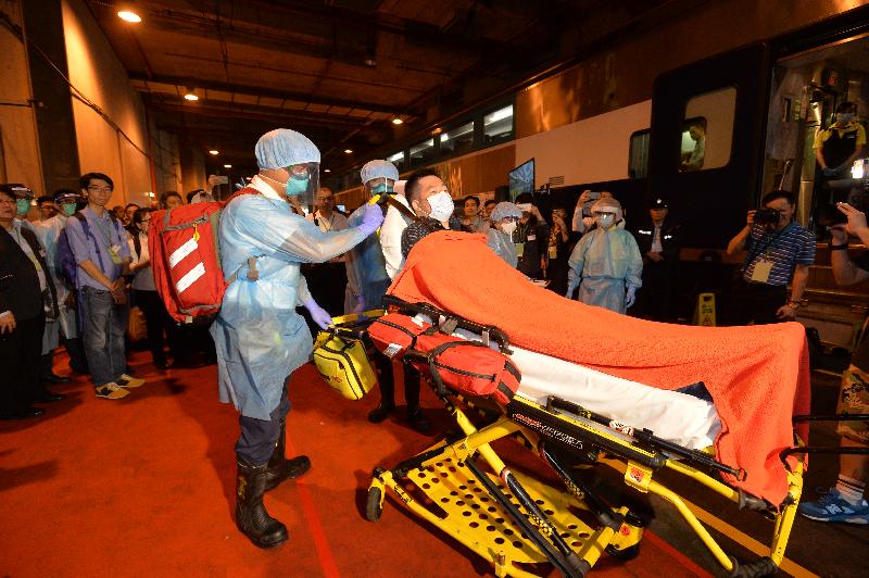 The Government tested its preparedness for a possible detection of Middle East Respiratory Syndrome today (November 16) during an exercise code-named "Beryl", organised by the Centre for Health Protection of the Department of Health in collaboration with other government departments and organisations at the Ho Tung Lau Depot of the MTR Corporation Limited. Photo shows the sick passenger being transferred from the train cabin to the ambulance by the Fire Services Department officers.
