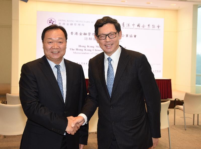 The Hong Kong Monetary Authority (HKMA) and the Hong Kong Chinese Enterprises Association (HKCEA) today (November 22) entered into a Memorandum of Understanding for a co-operation framework to help more Chinese enterprises to establish their corporate treasury centres in Hong Kong. Photo shows the Chief Executive of the HKMA, Mr Norman Chan (right), greeting the Chairman of the HKCEA, Mr Yue Yi.