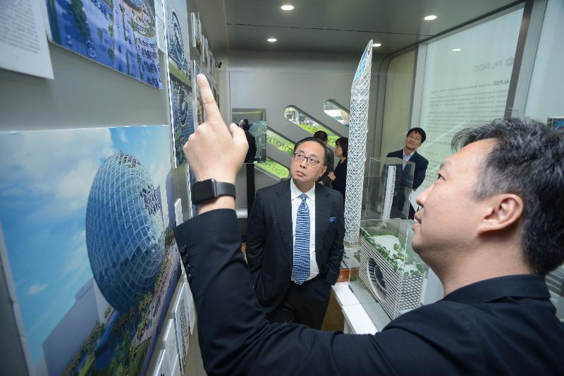 The Secretary for Innovation and Technology, Mr Nicholas W Yang (left), receives a briefing by the Founder and Chief Executive Officer of James Law Cybertecture, Mr James Law (right), on his design idea during his visit to the "Smart City in Smart Pod" exhibition at the Energizing Kowloon East Office today (November 25).
