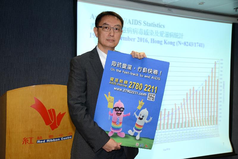 The Consultant (Special Preventive Programme) of the Centre for Health Protection of the Department of Health, Dr Kenny Chan, pictured today (November 29) with a poster of condom mascots in support of World AIDS Day on December 1. 