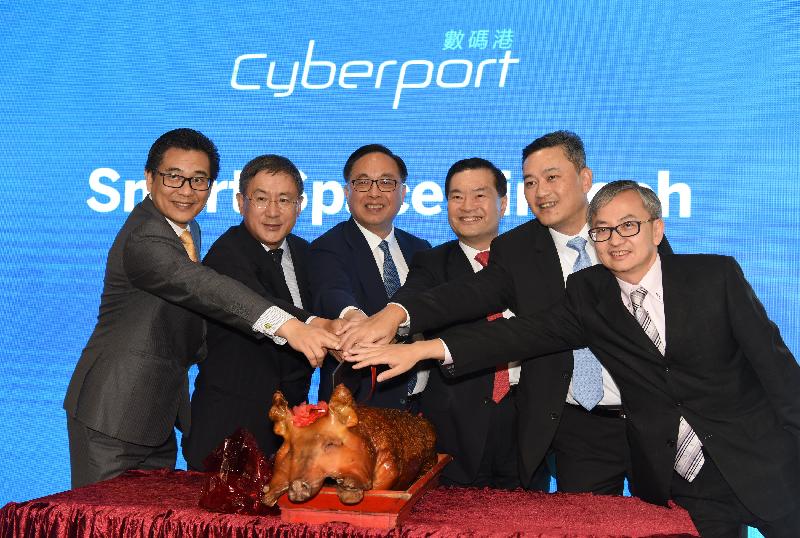 The Secretary for Innovation and Technology, Mr Nicholas W Yang (third left); the Chairman of the Board of Directors of Hong Kong Cyberport Management Company Limited, Dr George Lam (third right); the Permanent Secretary for Innovation and Technology, Mr Cheuk Wing-hing (second left); the Under Secretary for Innovation and Technology, Dr David Chung (first right); the Government Chief Information Officer, Mr Allen Yeung (first left); and the Chief Executive Officer of Hong Kong Cyberport Management Company Limited, Mr Herman Lam (second right), celebrate the opening of Smart-Space FinTech at Cyberport today (December 6) with a roast pig cutting ceremony.
