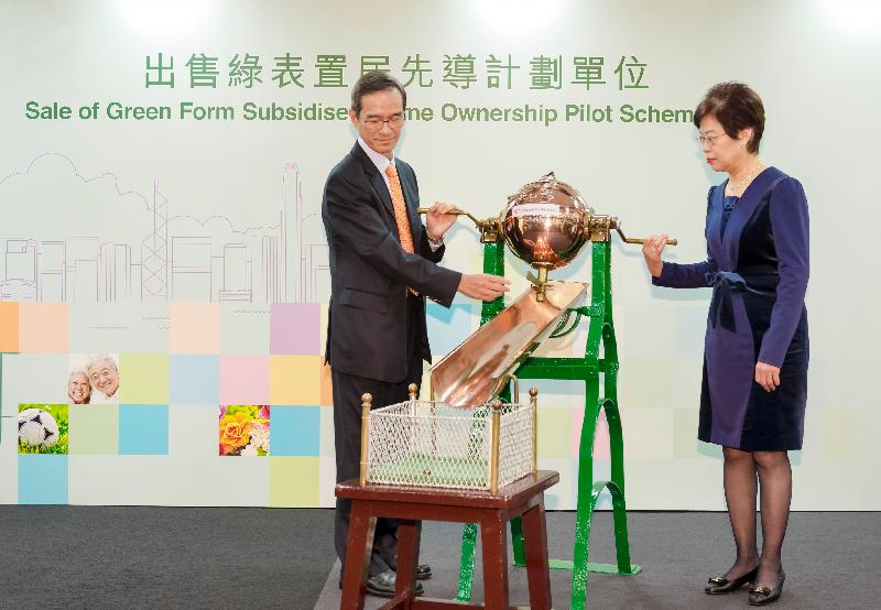 The Chairman of the Subsidised Housing Committee of the Hong Kong Housing Authority, Mr Stanley Wong (left), accompanied by the Assistant Director of Housing (Housing Subsidies), Mrs Rosa Ho, draws ballots today (December 8) for the Sale of Green Form Subsidised Home Ownership Pilot Scheme Flats to decide the sequence of detailed eligibility vetting and flat selection priority.
