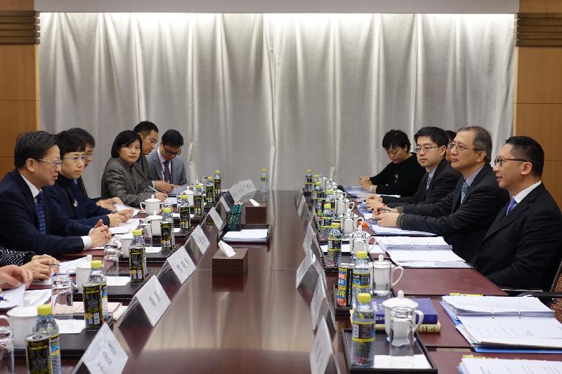 The Secretary for Justice, Mr Rimsky Yuen, SC, attended the annual high-level working meeting with the Department of Treaty and Law of the Ministry of Foreign Affairs (MFA) in Beijing today (December 8). Photo shows Mr Yuen (first right) and Law Officer (International Law) of the Department of Justice, Mr Paul Tsang (second right), meeting with the Director-General of the Department of Treaty and Law of the MFA, Mr Xu Hong (first left).