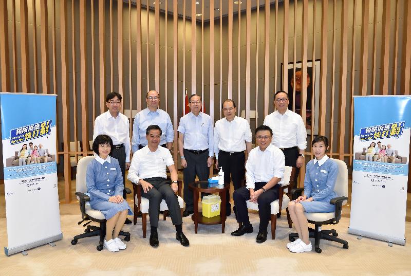 The Chief Executive, Mr C Y Leung (front row, second left), today (December 14) receive seasonal influenza vaccination together with the Acting Financial Secretary, Professor K C Chan (front row, second right); the Secretary for Labour and Welfare, Mr Matthew Cheung Kin-chung (back row, second right); the Secretary for Constitutional and Mainland Affairs, Mr Raymond Tam (back row, second left); the Secretary for Security, Mr Lai Tung-kwok (back row, centre); and the Secretary for Innovation and Technology, Mr Nicholas W Yang (back row, first right). Accompanying them is the Secretary for Food and Health, Dr Ko Wing-man (back row, first left).