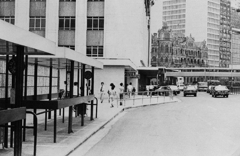 「沿途风光好：1970年代香港岛巴士站街景照片展」的其中一帧图片：一九七五年的干诺道中近皇后像广场的街头景貌及已拆卸的邮政总局大楼。