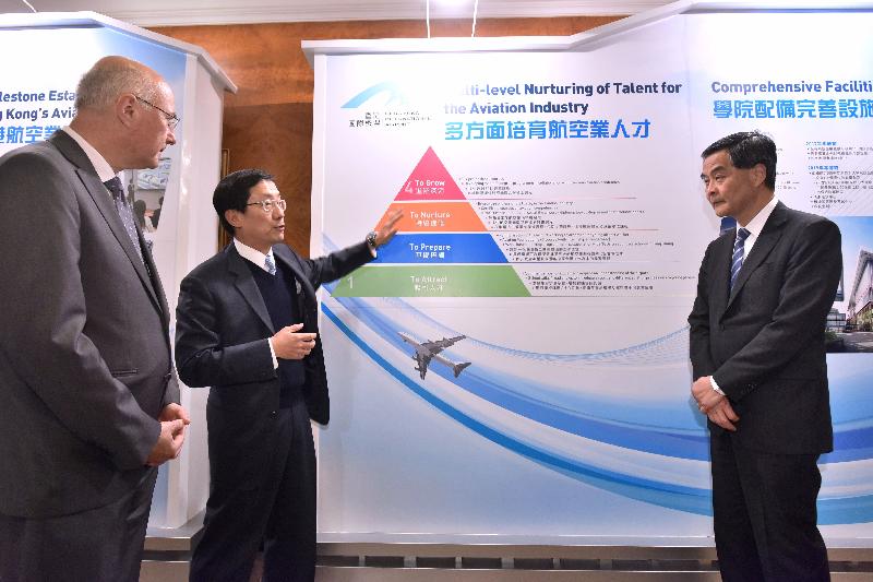 The Chief Executive, Mr C Y Leung, attended the Signing Ceremony for the Collaboration between Hong Kong International Aviation Academy and Ecole Nationale de l'Aviation Civile this afternoon (December 16). Photo shows Mr Leung (right) touring the related exhibition.