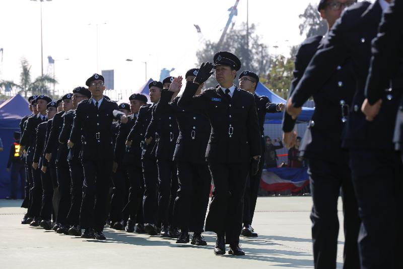 The Civil Aid Service (CAS) held the 77th Recruits Passing-out Parade at its headquarters today (December 18). Picture shows the parade marching pass the review stand and saluting to the Reviewing Officer, the Chief Staff Officer and Deputy Commissioner (Operations) of the CAS, Mr Lam Kwok-wah.