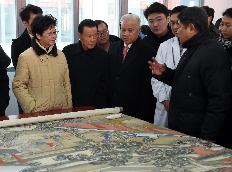 The Chief Secretary for Administration, Mrs Carrie Lam, attended the unveiling ceremony of the Hospital for Conservation, the Palace Museum Learning Centre and the Jianfu Honour Roll of Architectural Conservation Donors at the Palace Museum in Beijing this afternoon (December 29). Photo shows Mrs Lam (first left) being briefed by the Director of the Palace Museum, Dr Shan Jixiang (first right), on conservation of a Chinese painting at the Hospital.