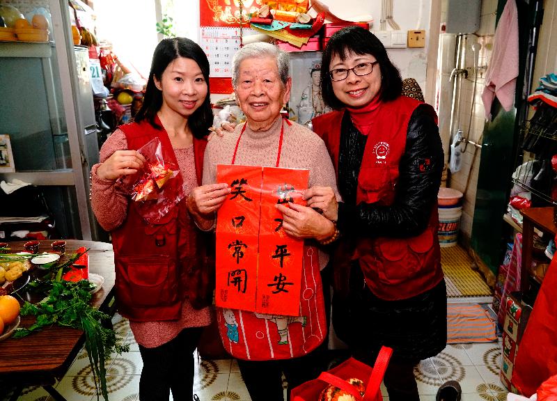 The Housing Department (HD) Volunteers Corps visited elderly tenants in Mei Lam Estate, Sha Tin last Saturday (January 21). Photo shows members of the HD Volunteers Corps giving an elderly tenant handmade fai chun and festive gifts.