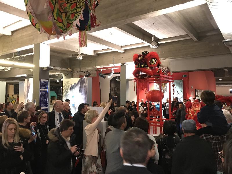 At the opening reception for Legends of Lion Dance exhibition on January 27, the crowd takes photos of the exhibits and the lion dance performers at the Permeke Library in Antwerp, Belgium.