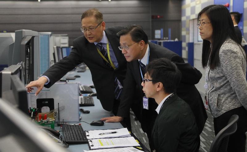 Accompanied by the Director-General of Civil Aviation, Mr Simon Li (first left), the Secretary for Transport and Housing, Professor Anthony Cheung Bing-leung (second left), receives a briefing on the operation of the new Air Traffic Management System at the new Air Traffic Control (ATC) Centre and the ATC Tower this afternoon (February 7).
