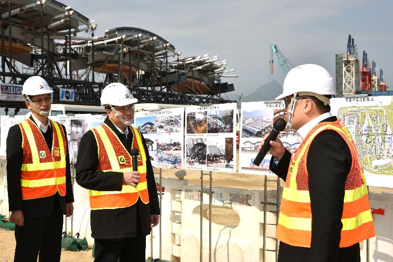 The Secretary for Transport and Housing, Professor Anthony Cheung Bing-leung (centre), accompanied by the Director of Highways, Mr Daniel Chung (left), receives a briefing by the Project Manager of the Hong Kong-Zhuhai-Macao Bridge (HZMB) Hong Kong Project Management Office of the Highways Department, Mr Albert Lee (right), on the construction of the Passenger Clearance Building when inspecting the works progress of the HZMB Hong Kong Boundary Crossing Facilities and the Hong Kong Link Road this afternoon (February 9).
