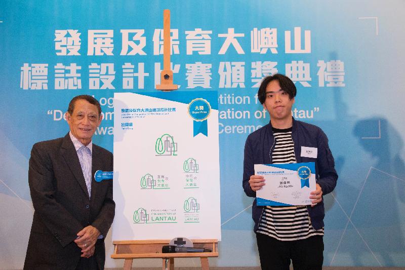 The award presentation ceremony for the Logo Design Competition for Development and Conservation of Lantau organised by the Civil Engineering and Development Department was held at the City Gallery in Central today (March 18). Photo shows the Chairman of the Islands District Council and Non-official Member of the Lantau Development Advisory Committee, Mr Chow Yuk-tong (left), presenting the grand prize for the Open Group to the winner.