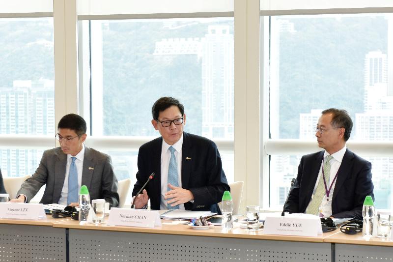 The Chief Executive of the Hong Kong Monetary Authority, Mr Norman Chan (centre), gives opening remarks at the Debt Financing and Investors' Roundtables today (March 24).