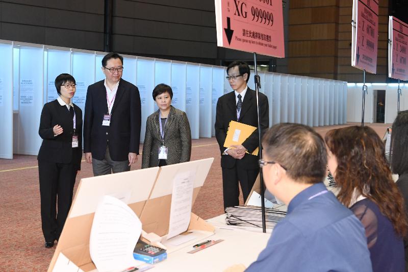 The Chairman of the Electoral Affairs Commission, Mr Justice Barnabas Fung Wah (second left) and the Returning Officer, Madam Justice Carlye Chu Fun-ling (second right), were briefed by the Presiding Officer on the voting procedures during their visit to the main polling station of the 2017 Chief Executive Election in the Hong Kong Convention and Exhibition Centre this morning (March 25). Also present is the Chief Electoral Officer, Mr Wong See-man (first right).