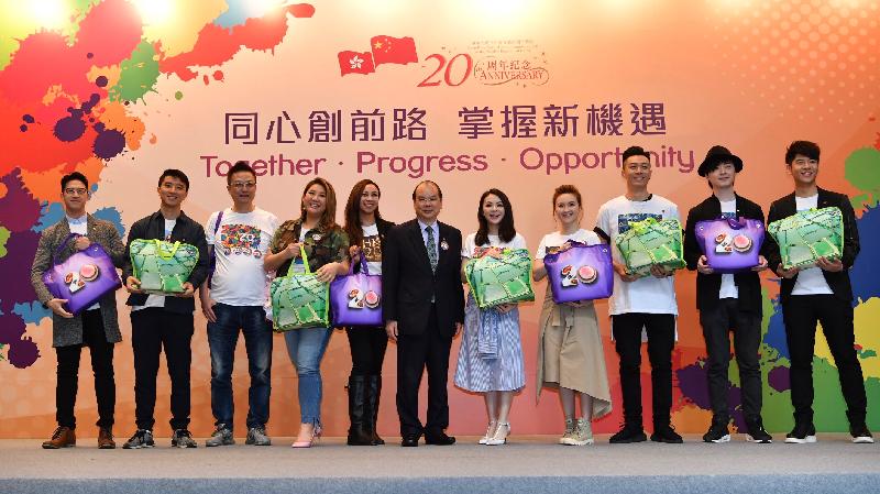 A theme song, "Hong Kong．Our Home" has been produced to celebrate the 20th anniversary. Composed by T-Ma and Jay Fung, with lyrics by Jolland Chan, the song is performed by local singers including Pakho Chau, Joyce Cheng, AGA, JW, Ken Hung, Alfred Hui and Mag Lam who attended a press conference today (April 6) with the Chief Secretary for Administration, Mr Matthew Cheung Kin-chung (centre).