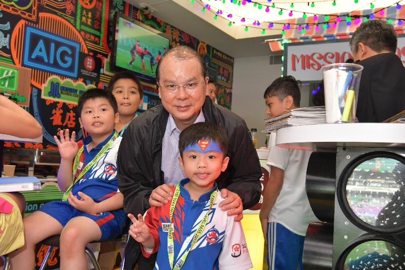 政务司司长暨扶贫委员会主席张建宗今日（四月八日）在香港国际七人榄球赛中主持Mission Possible儿童派对。图示张建宗（中）与儿童一起观赏香港国际七人榄球赛。