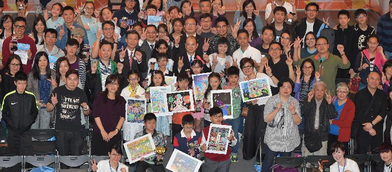 The Chief Secretary for Administration, Mr Matthew Cheung Kin-chung, takes a group photo with awardees and other participants at the HKSAR 20th Anniversary Poster Design and Video Competitions Prize Presentation and Roving Exhibition Launching Ceremony today (April 14).