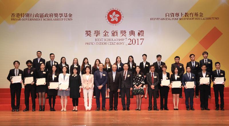 The Secretary for Education, Mr Eddie Ng Hak-kim (front row, centre), today (April 18) is pictured with students who were offered scholarships under the HKSAR Government Scholarship Fund at the HKSAR Government Scholarship Fund and Self-financing Post-secondary Education Fund Joint Scholarship Presentation Ceremony.