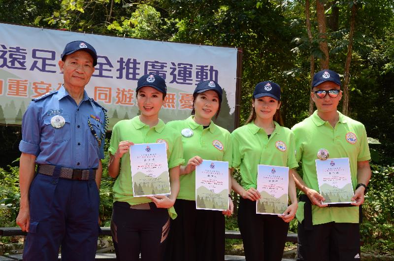 The Commissioner of the Civil Aid Service, Dr Ernest Lee (first left), presents appointment certificates to four Honorary Hiking Safety Ambassadors today (May 3).