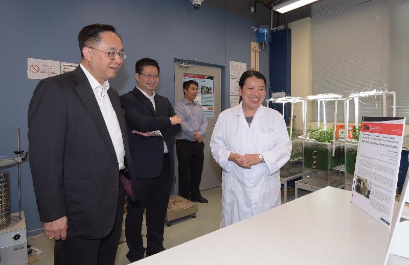 During his visit to the Technological and Higher Education Institute of Hong Kong this afternoon (May 12), the Secretary for Innovation and Technology, Mr Nicholas W Yang (first left), tours the Geotechnical and Geo-environmental Laboratory where the research team presents the study of an "eco-garden" aiming at improving indoor and roadside air quality. Looking on is the Chairman of the Kwai Tsing District Council, Mr Law King-shing (second left).