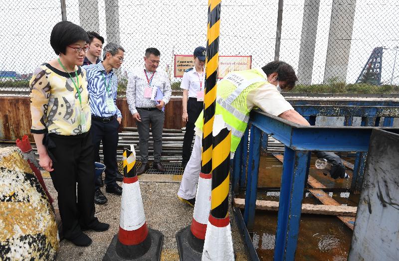 The Government tested its preparedness for a possible detection of Zika Virus Infection today (May 12) during an exercise code-named "Moonstone", organised by the Centre for Health Protection (CHP) of the Department of Health (DH) in collaboration with other government departments and organisations at the Container Terminal 8 West, Kwai Chung, Hong Kong. Photo shows the Director of Health, Dr Constance Chan (first left) and the Controller of the CHP of the DH, Dr Wong Ka-hing (second left), inspecting the exercise at the Container Terminal. Personnel of the Food and Environmental Hygiene Department carrying out mosquito  control measures over stagnant water.