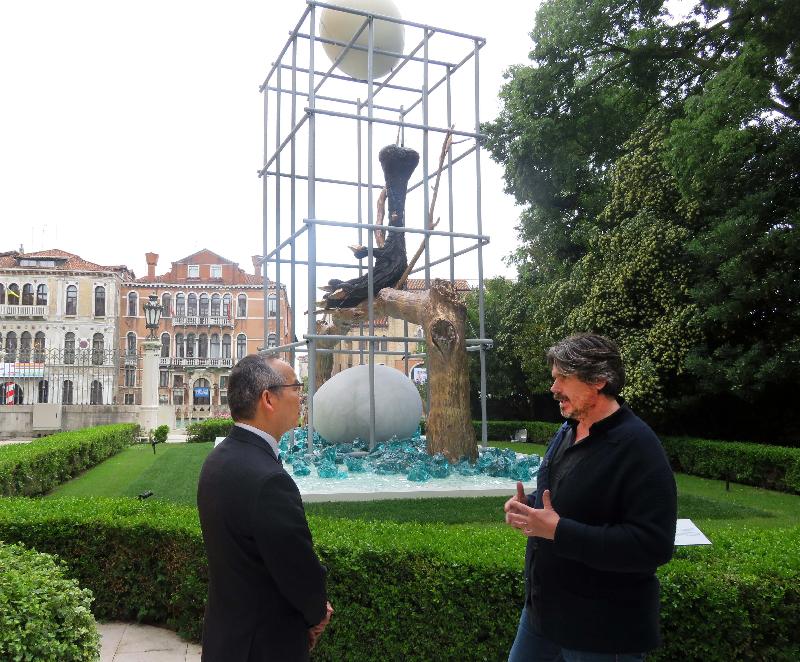 The Secretary for Home Affairs, Mr Lau Kong-wah (left), listens to an introduction from Belgian artist Koen Vanmechelen on his artwork in Venice, Italy, yesterday (May 11, Venice time).