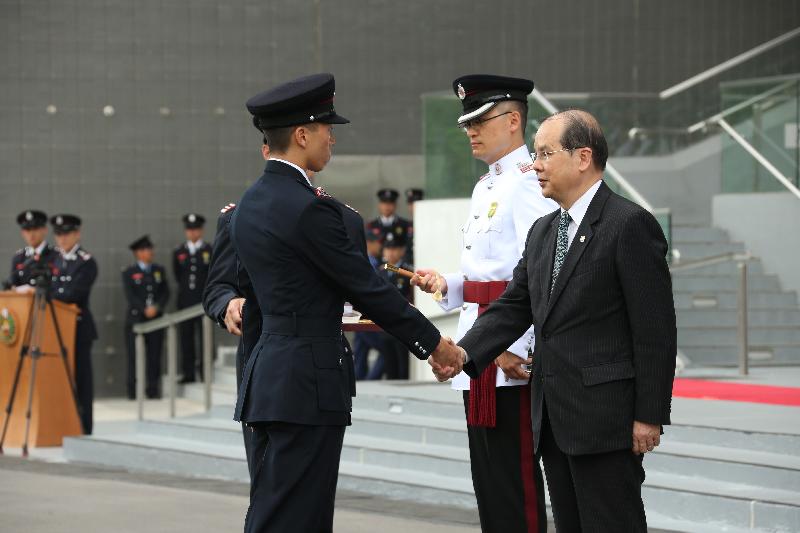 The Chief Secretary for Administration, Mr Matthew Cheung Kin-chung, reviewed the 178th Fire Services passing-out parade at the Fire and Ambulance Services Academy today (May 12). Picture shows Mr Cheung (right) presenting the Best Recruit award to a graduate.